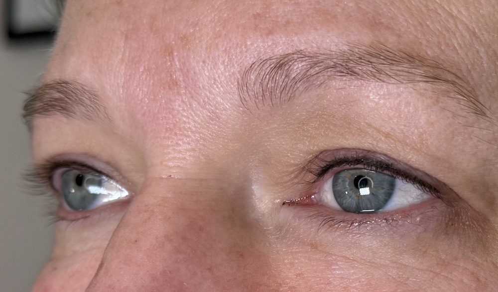 Close-up of lash enhancement liner tattoo